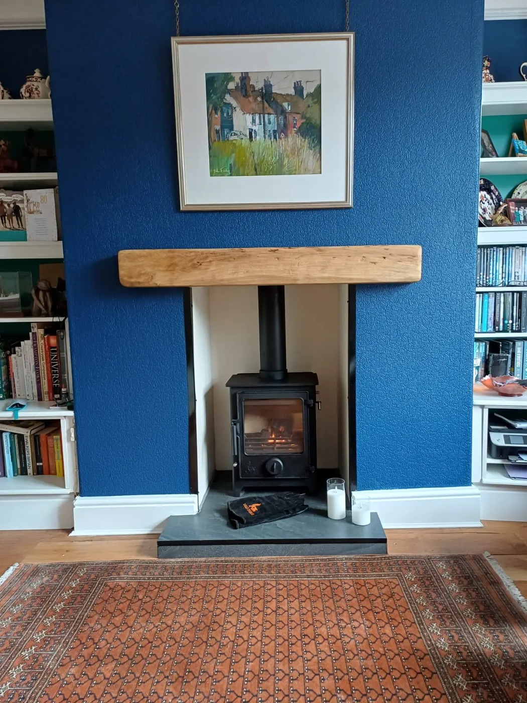 Stove with oak beam in a blue living room